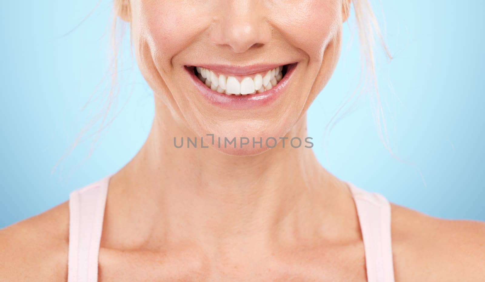 Smile, teeth whitening and woman mouth in studio, blue background and facial wellness. Closeup female model, clean dental and happy face of fresh breath, tooth implant and healthy aesthetic beauty by YuriArcurs