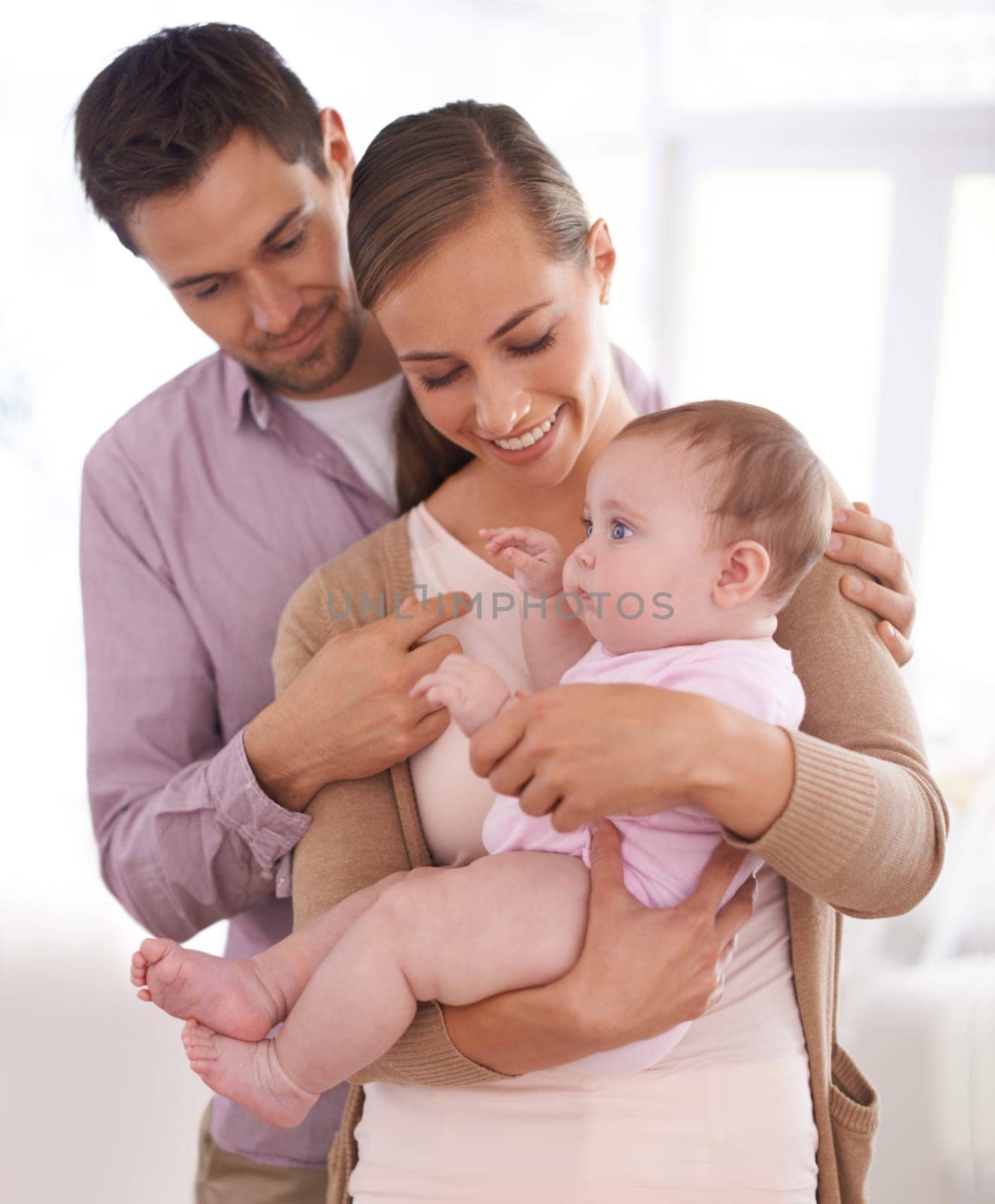 No stronger bond than parent and child. a father holding his little baby girl in his arms