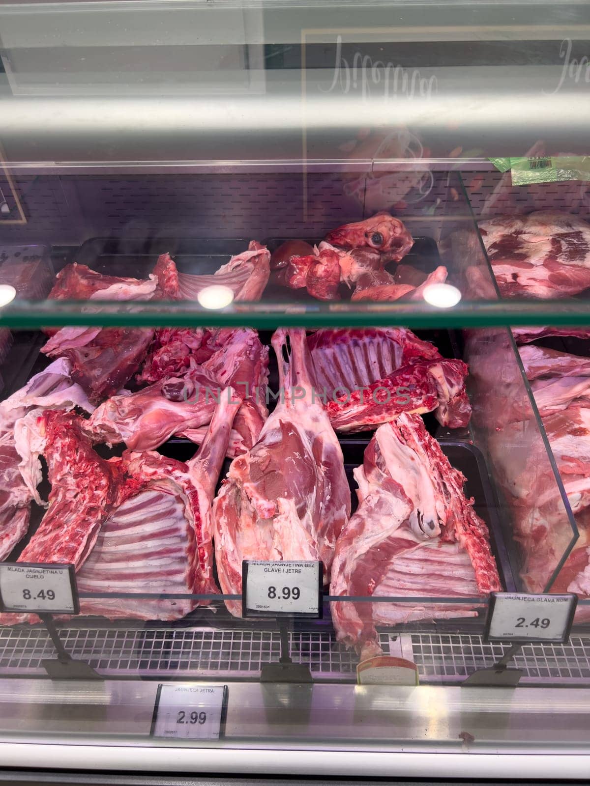 Raw lamb meat on the ribs lies in the refrigerator in the supermarket. High quality photo