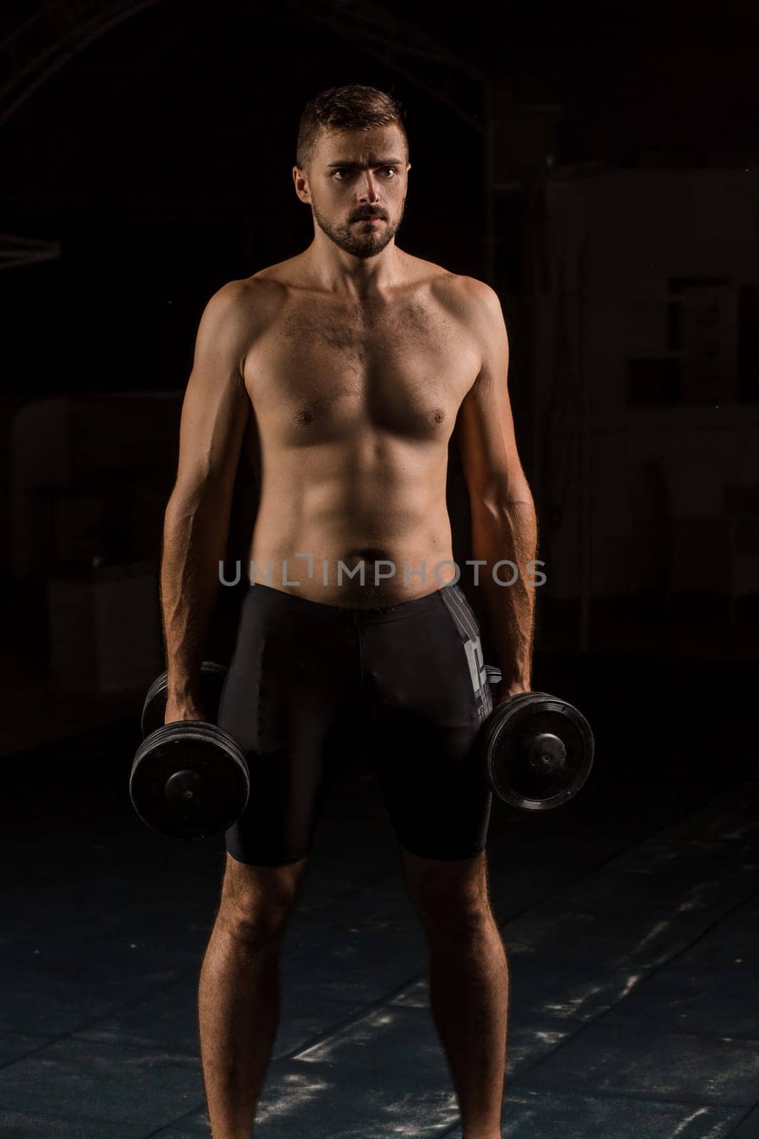 Muscular bodybuilder handsome man doing exercises in outdoor gym naked torso. Athlete Outdoors.