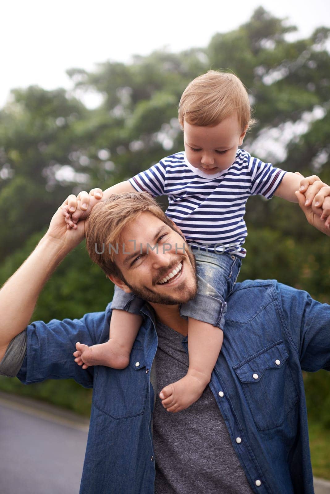 On top of the world. young father and his baby boy enjoying a day outside