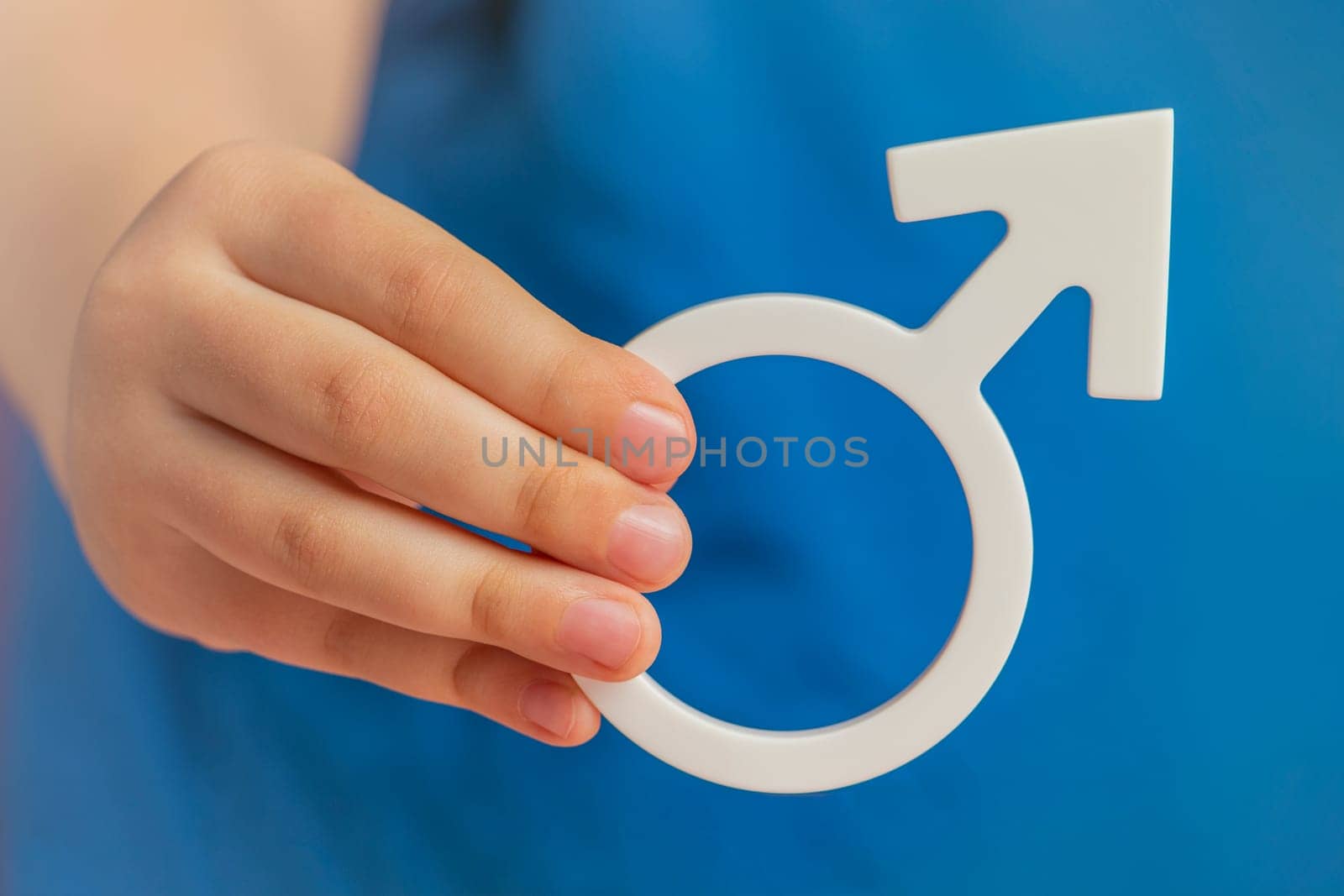 Gender symbol of a man. Symbol of a man in his hands on a blue background. The concept of male leadership or gender equality. by SERSOL