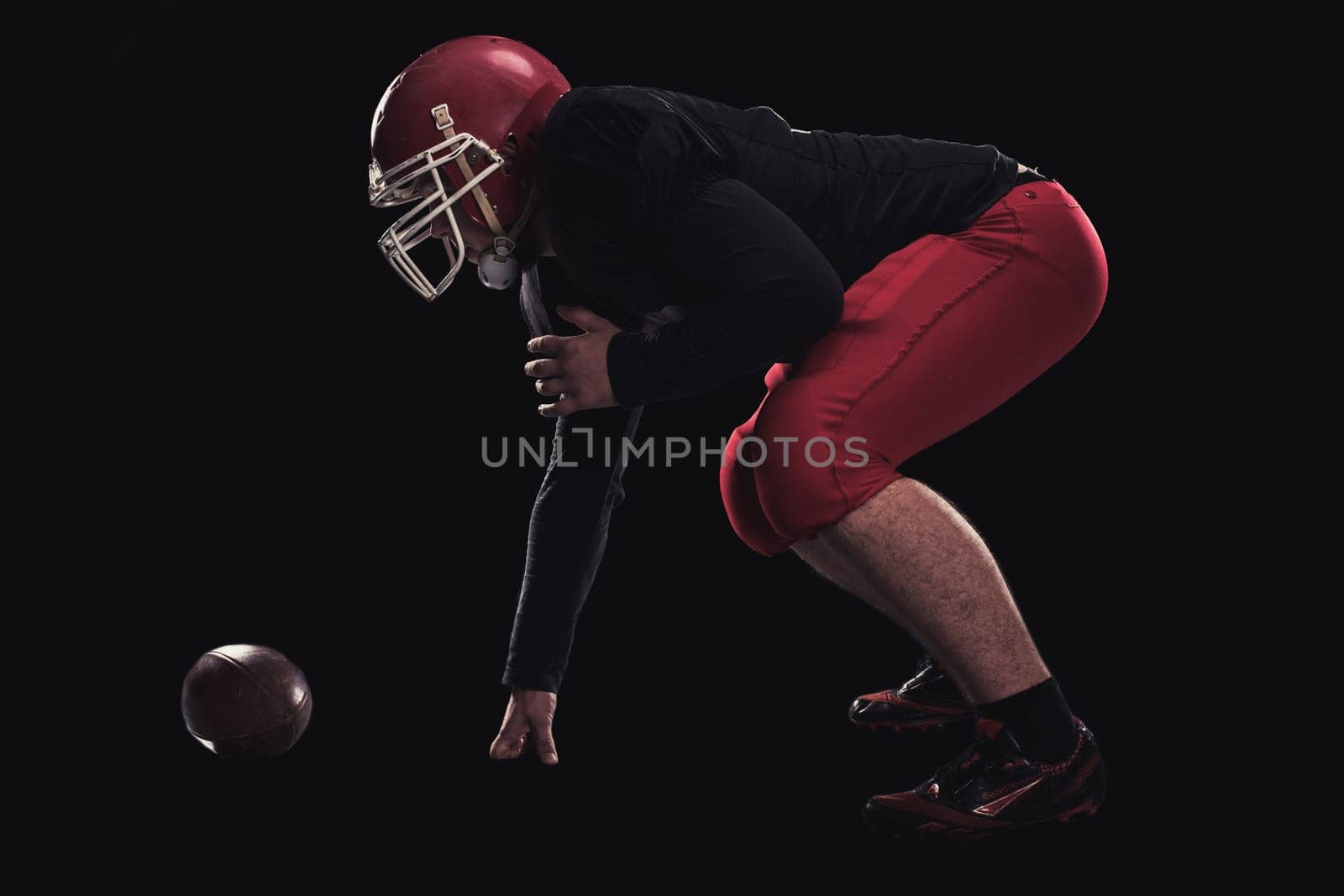 Soccer player on a dark background in vintage style. The classic American game. college Students. player game first before the attack