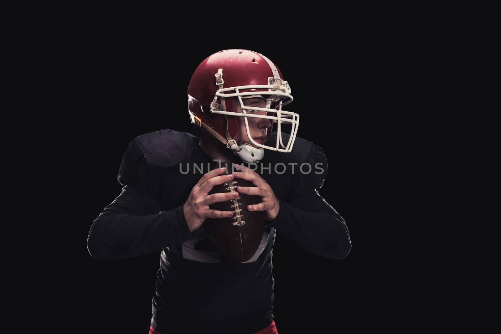 Soccer player on a dark background in vintage style. The classic American game. college Students. He makes the ball roll