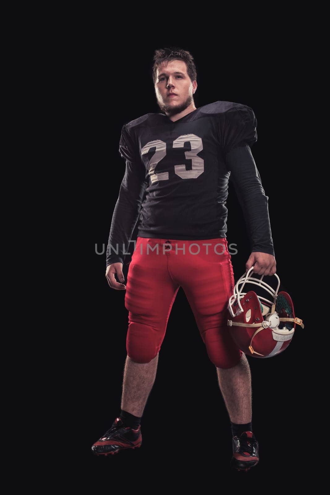Soccer player on a dark background in vintage style. The classic American game. college Students