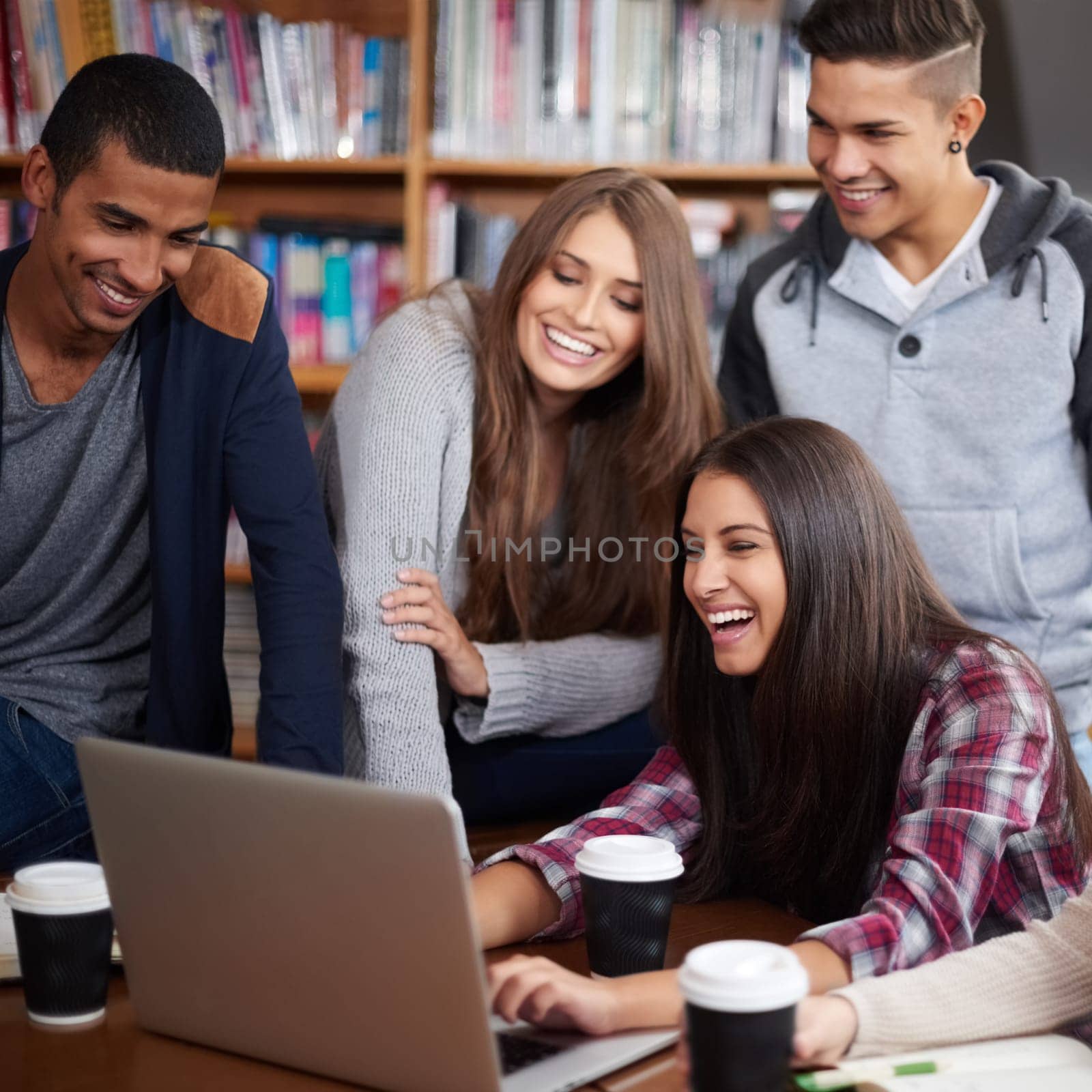 Education, happy and people in library on laptop for social media, online learning and meme. University, diversity and happy men and women students on computer for knowledge, internet and website.