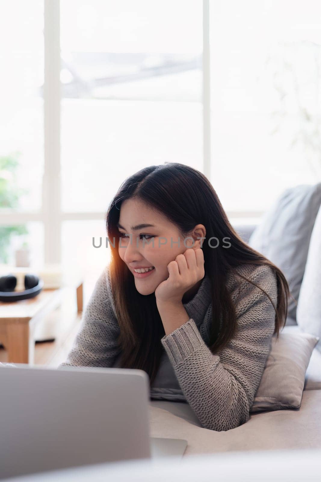 Attractive Asian woman resting comfortable living room and using laptop computer, Relax, Sofa, Lifestyle.