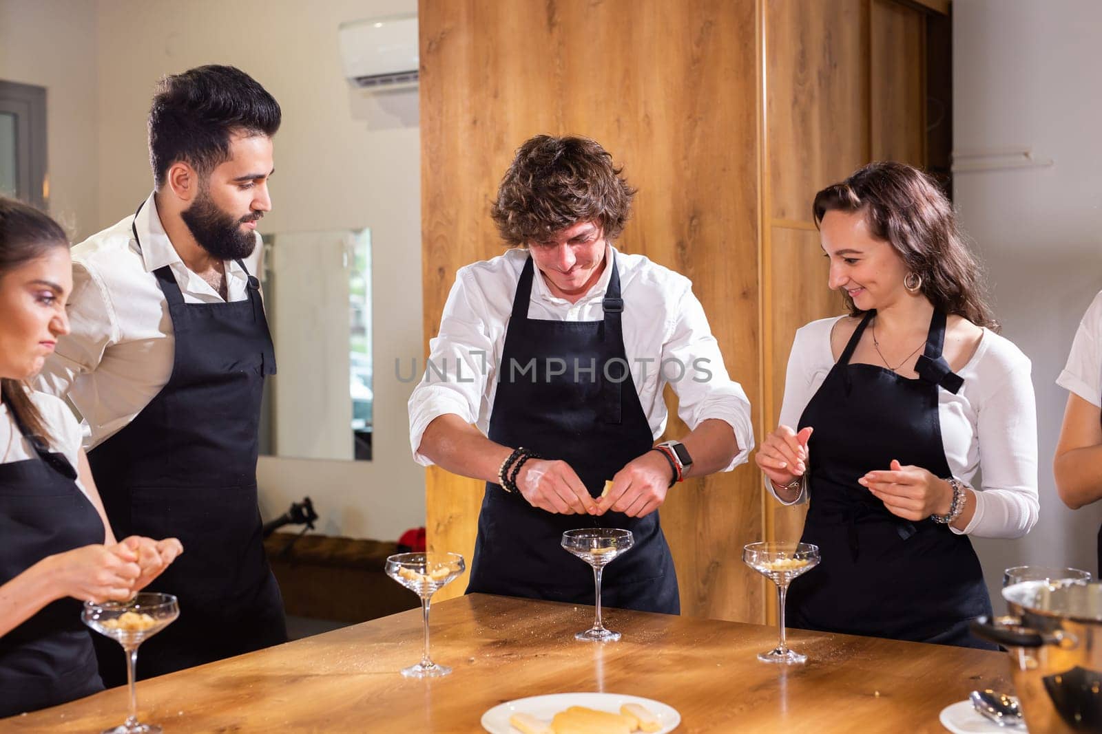 Chef teaching trainees how to make ice cream. Cooking tasty ice cream dessert made from chocolate and vanilla in glass bowl by Satura86