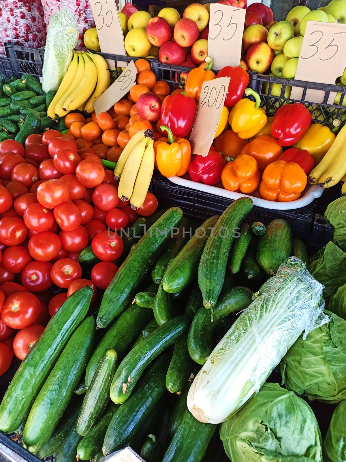Close-up fresh organic vegetables and fruits on shelf in farmers market or local bazaar. Agricultural business, industry by artgf