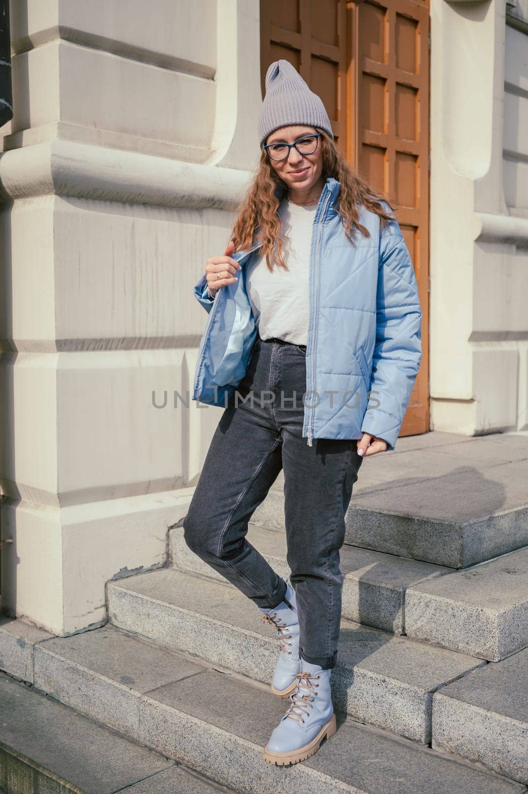 Portrait of a stylish woman in blue jacket. Spring outdoor portrait.