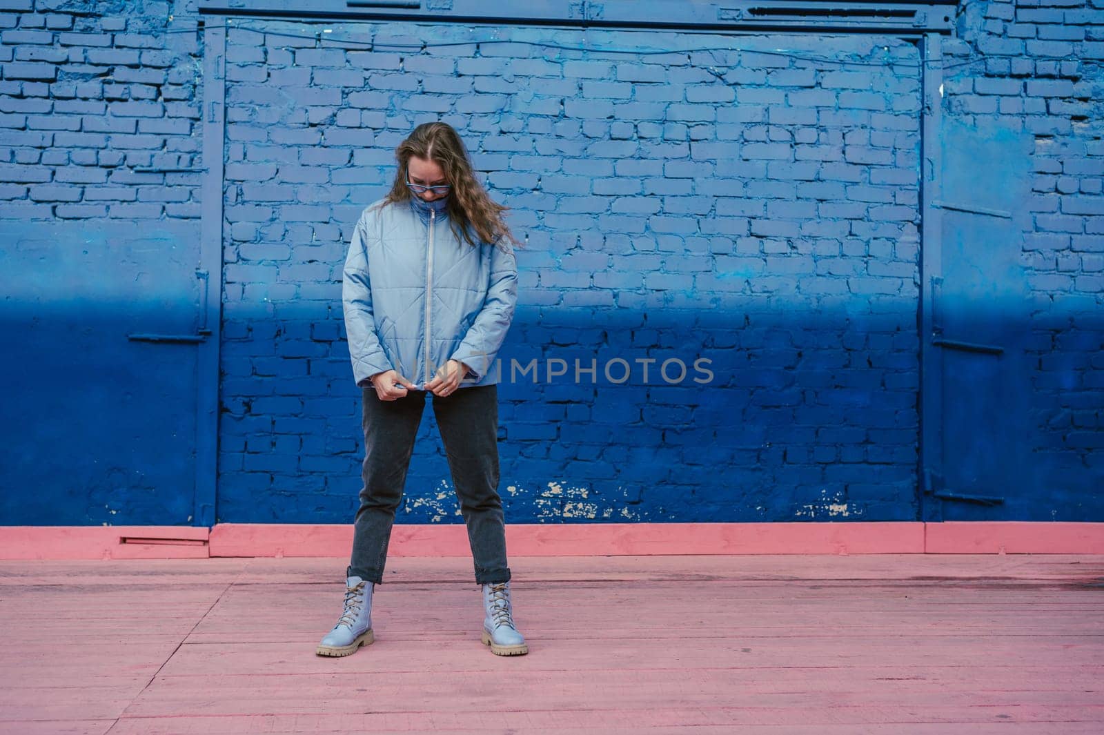 Portrait of a stylish woman in blue jacket. Spring outdoor portrait.