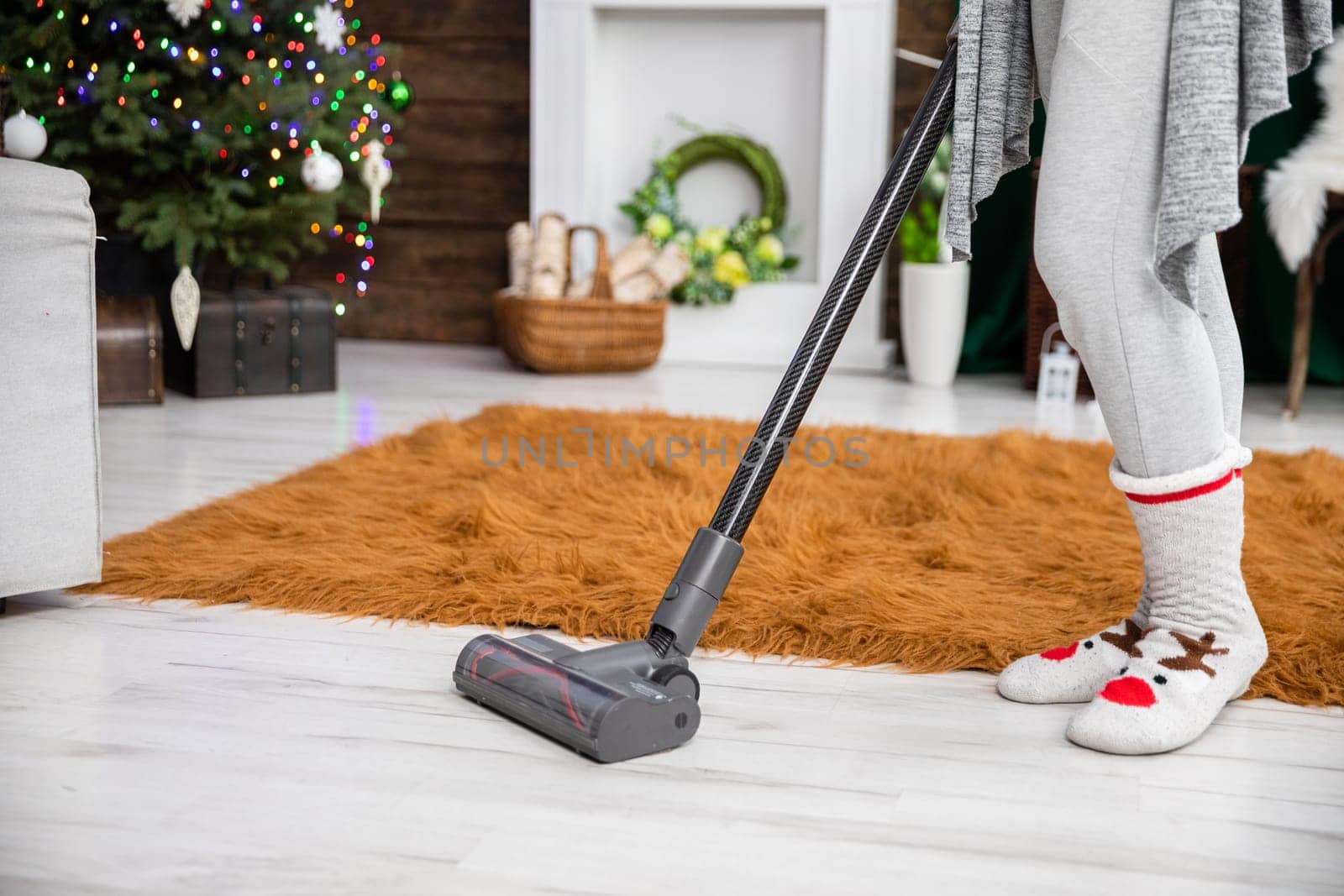 Thorough vacuuming of the floor before the celebration of an important Christian beheading. A decorated living room for Christmas.