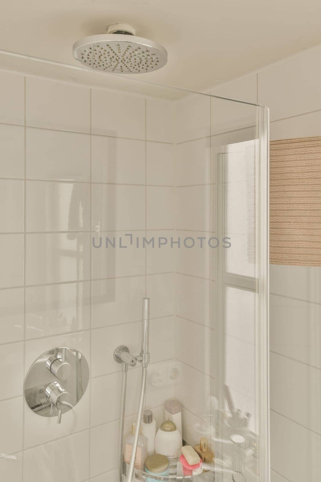 a white bathroom with a shower and a window by casamedia