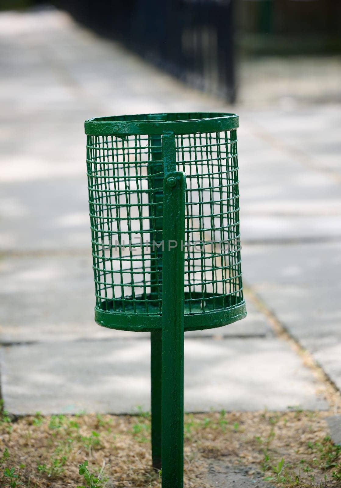 Empty trash can on city street by ndanko