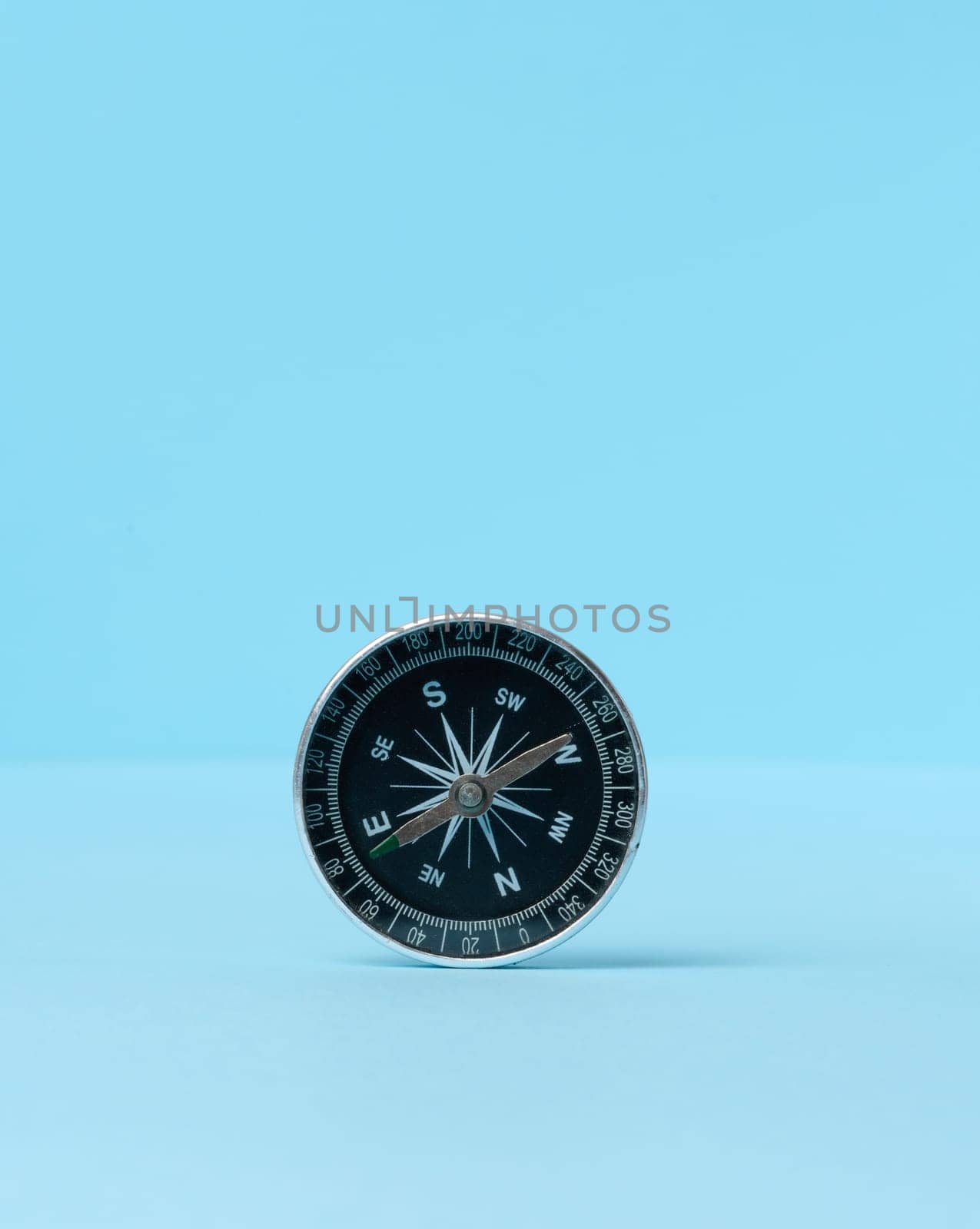 Round compass on a blue background by ndanko