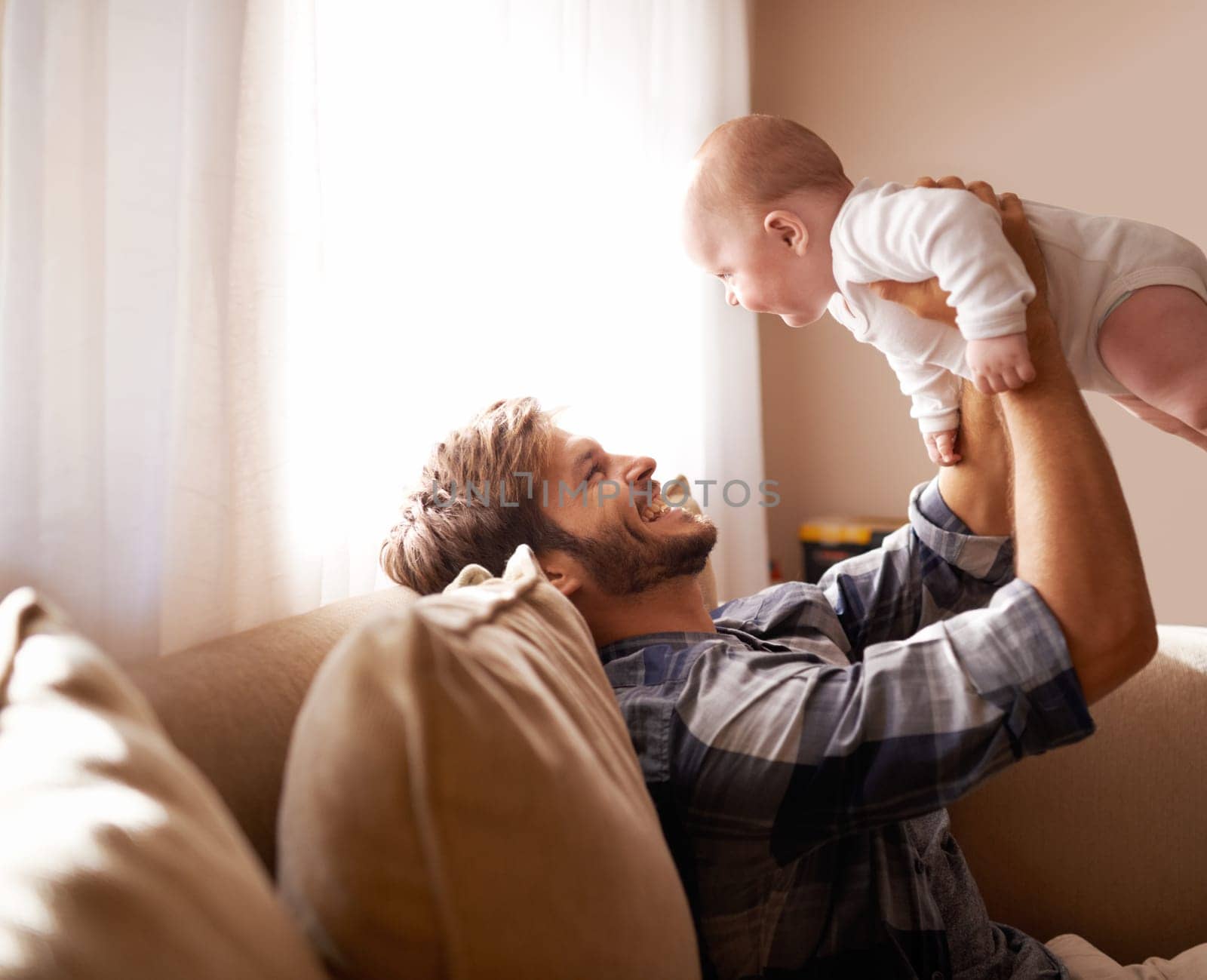 Shot of a father playing with his baby boy.