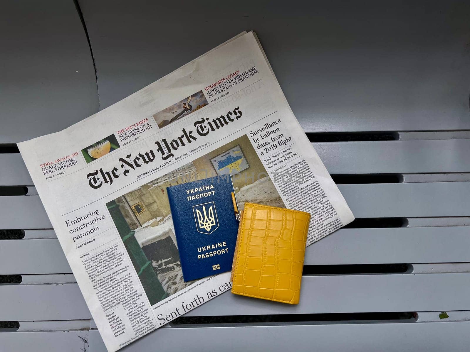 Ukrainian Refugee Passpart, money euro, popular newspaper The New The New York Times about Ukraine and Yellow Wallet. Flatley travel close up , vertical