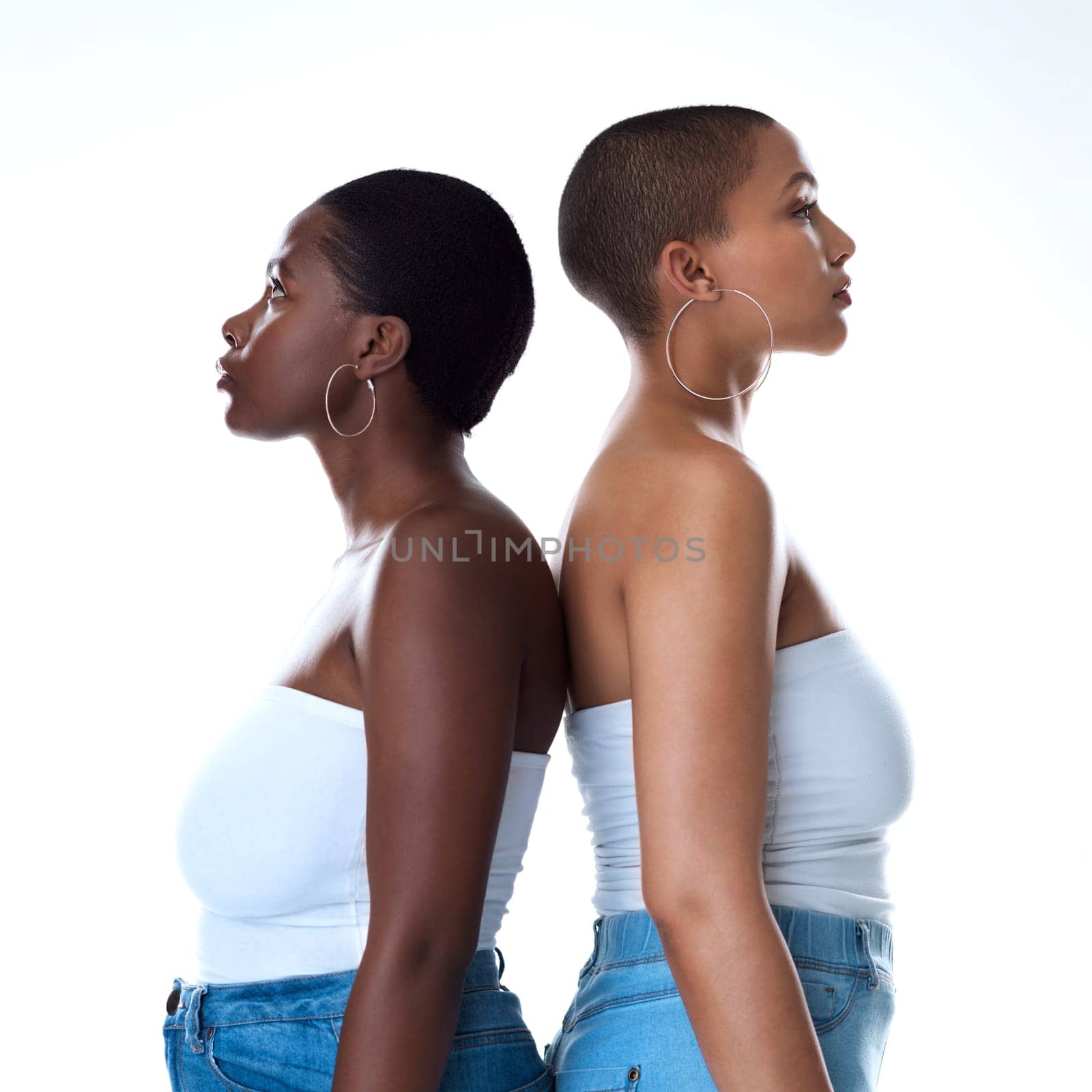 Back to back we got each other. Portrait of two beautiful women standing back to against a white background. by YuriArcurs