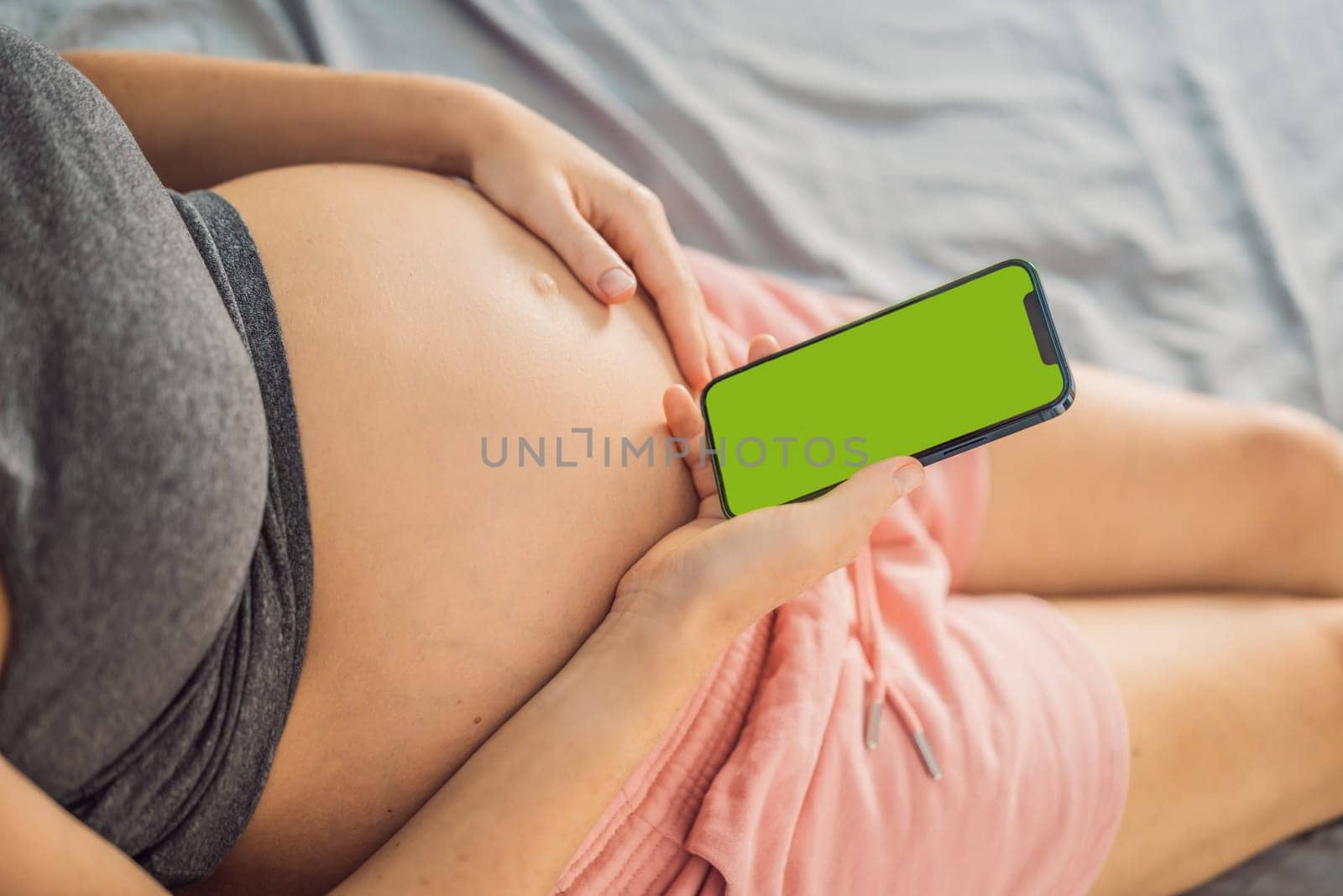 Pregnancy mockup app. Mobile pregnancy online maternity application. Pregnant mother using phone mock up. Pregnancy, medicine, pharmaceutics, health care and people concept.
