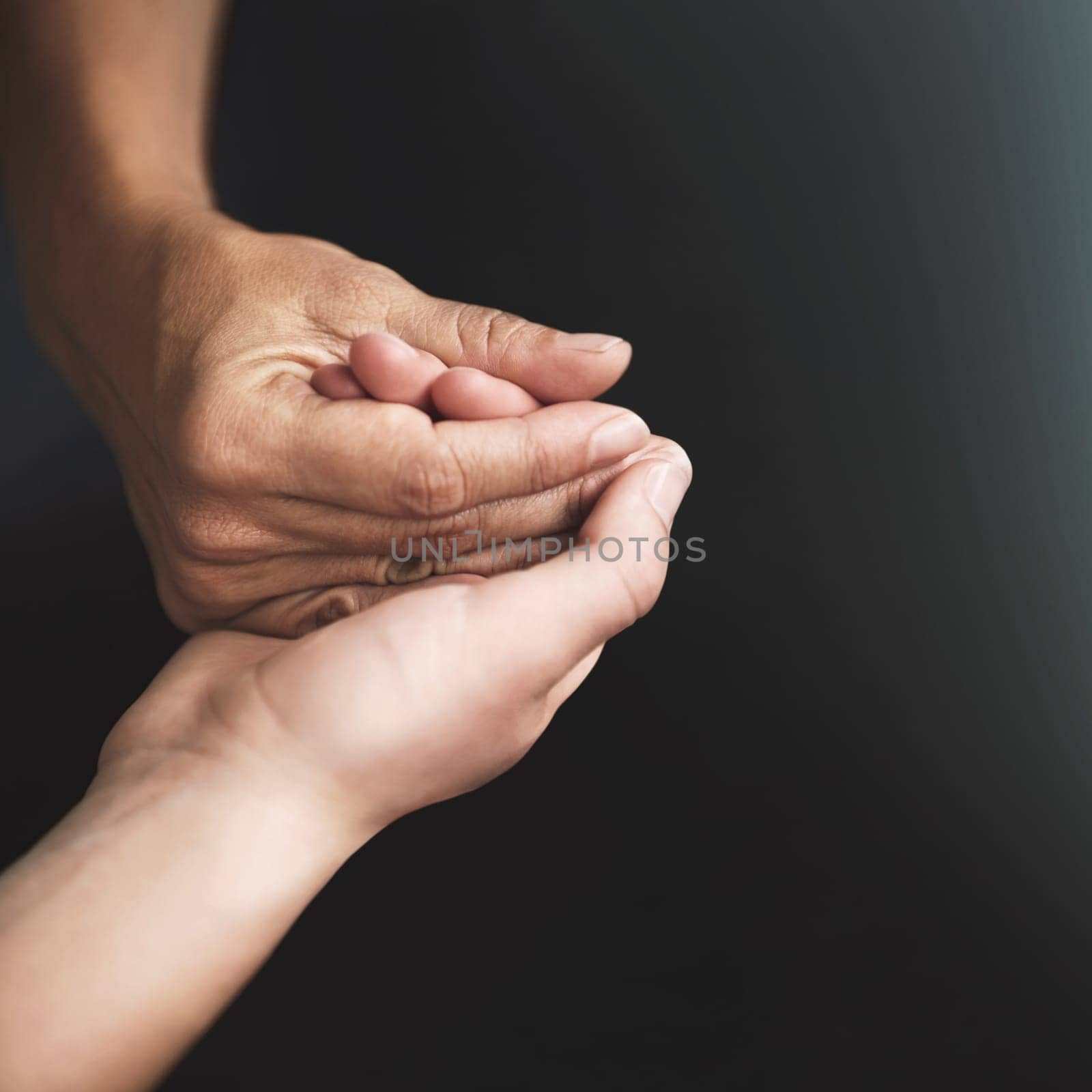 Cropped shot of two people holding hands in comfort.