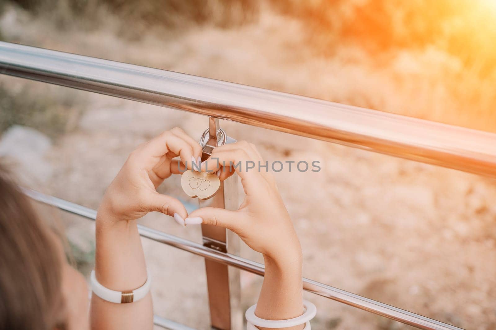 Hands, lock, heart, love, valentines day. Close-up of a woman's hands holding heart shaped padlock with a heart. The concept of Valentine's day, wedding, symbol of love and fidelity. by panophotograph