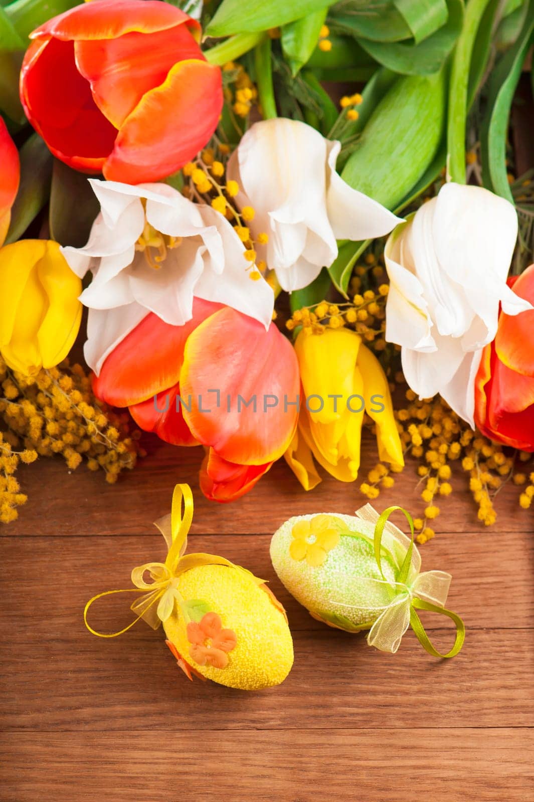 Yellow, red and white spring flowers on wooden background, tulips. by aprilphoto