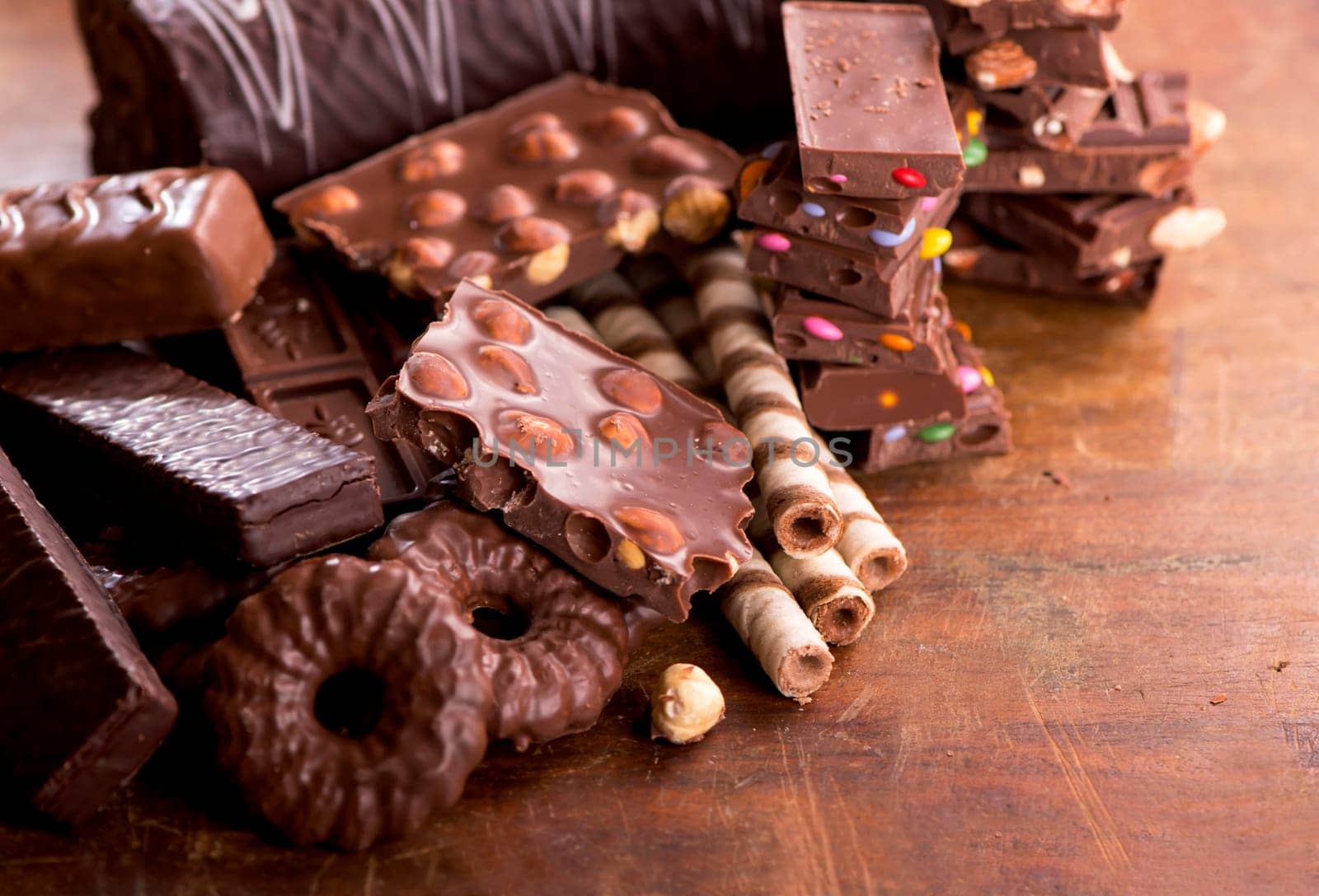 Sweets with nuts and chocolate. gingerbread cookies and chocolate on a wooden background by aprilphoto