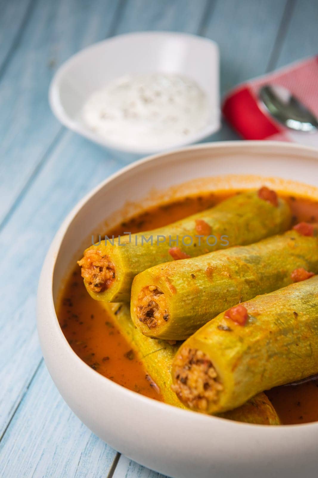 Recipe of stuffed courgette with tomato sauce, Lebanese style, Kouca Mehchi bi Banadoura, with Greek yogurt. High quality photo