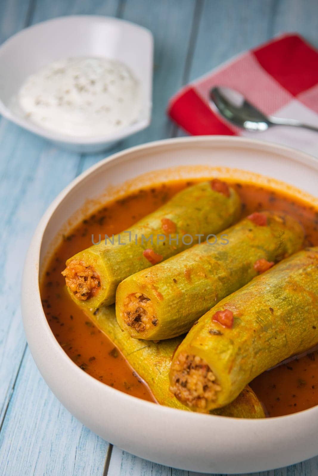 Recipe of stuffed courgette with tomato sauce, Lebanese style, Kouca Mehchi bi Banadoura, with Greek yogurt. High quality photo