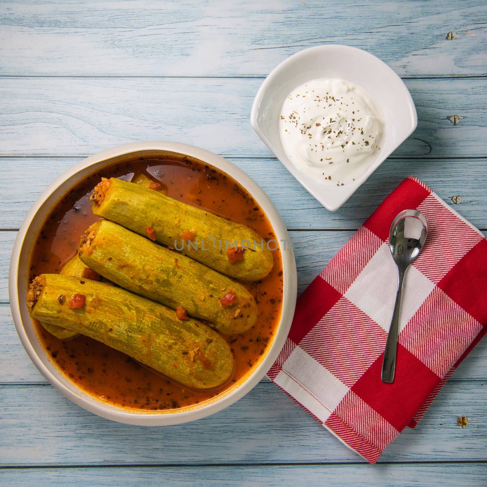 Recipe of stuffed courgette with tomato sauce, Lebanese style, Kouca Mehchi bi Banadoura, with Greek yogurt. High quality photo