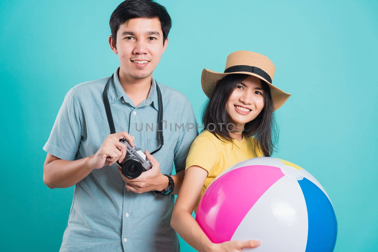 young beautiful woman handsome man couple in summer in holiday travel beach accessories by Sorapop
