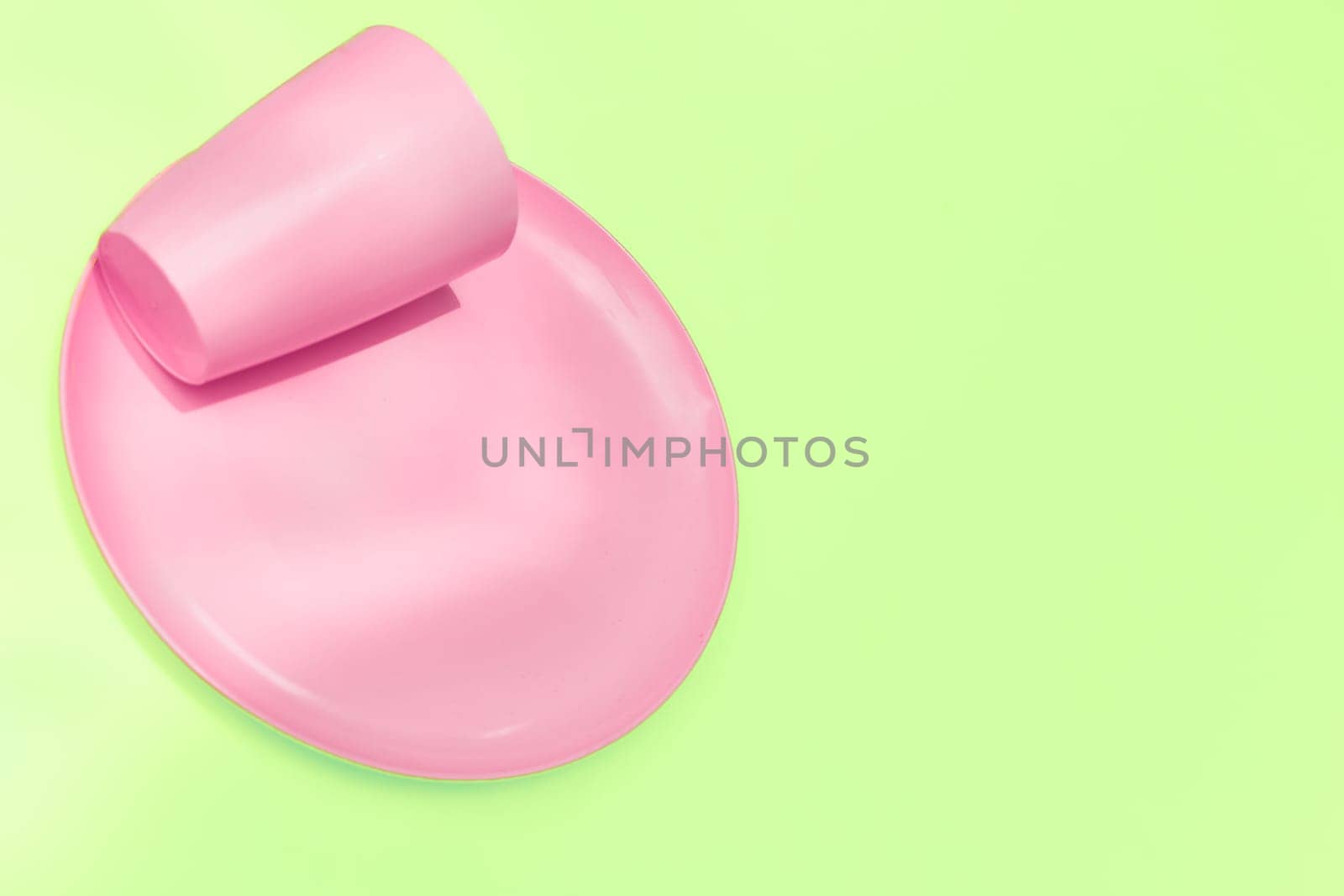 put, lay, or stand something in a specified place or position. Pink plastic camping spoons and forks isolated on white.