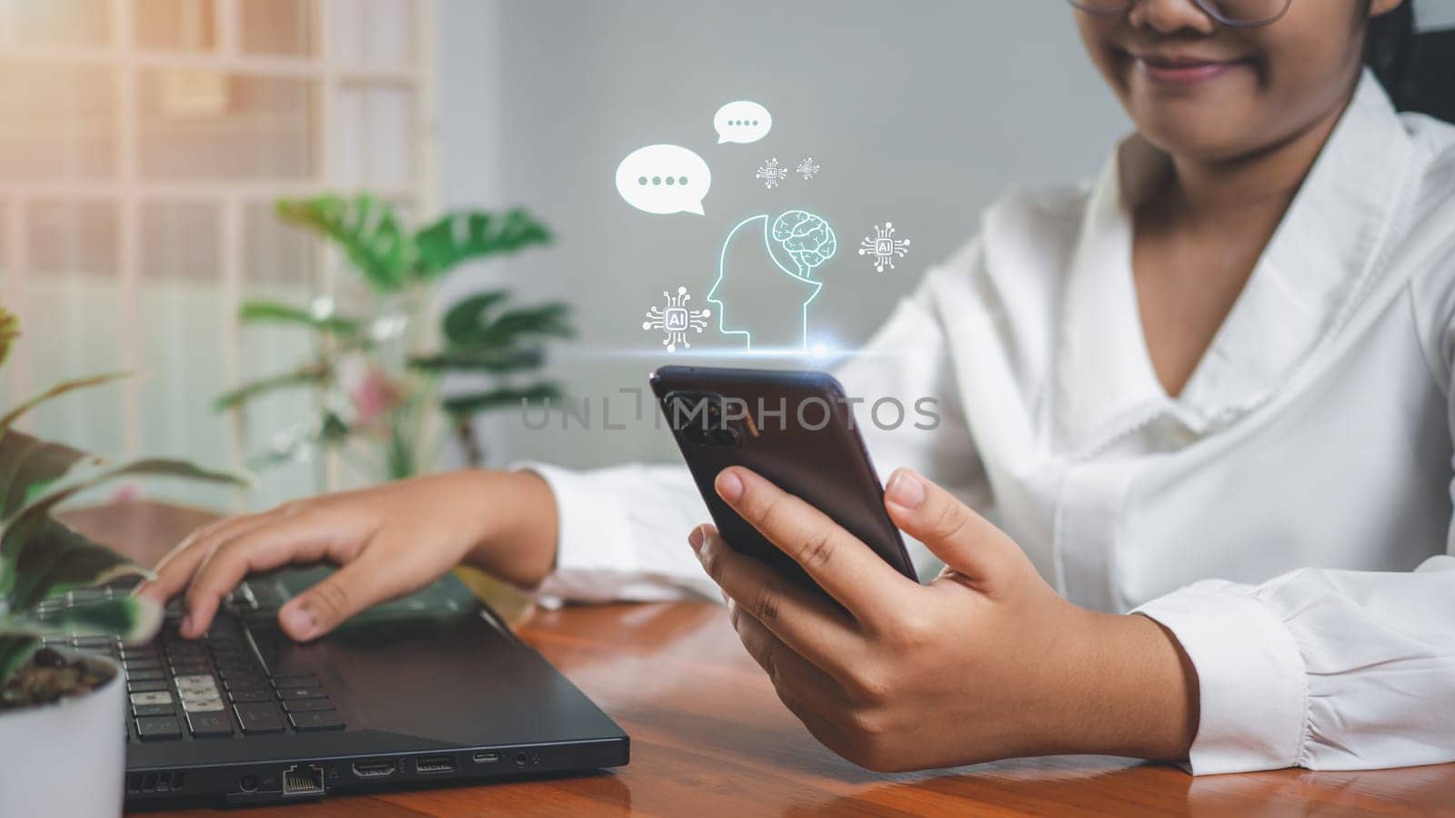Businesswoman hand uses a smartphone to type live chat, ask, answer with an artificial intelligence system. chat bot. Ai. by Unimages2527