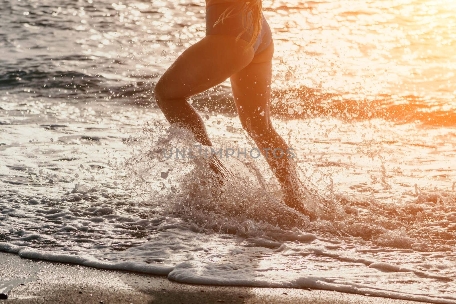 Running woman. Female runner jogging during the sunrise on beach. Woman Runner feet running on the beach at sunrise. woman fitness sunrise jog workout wellness concept.