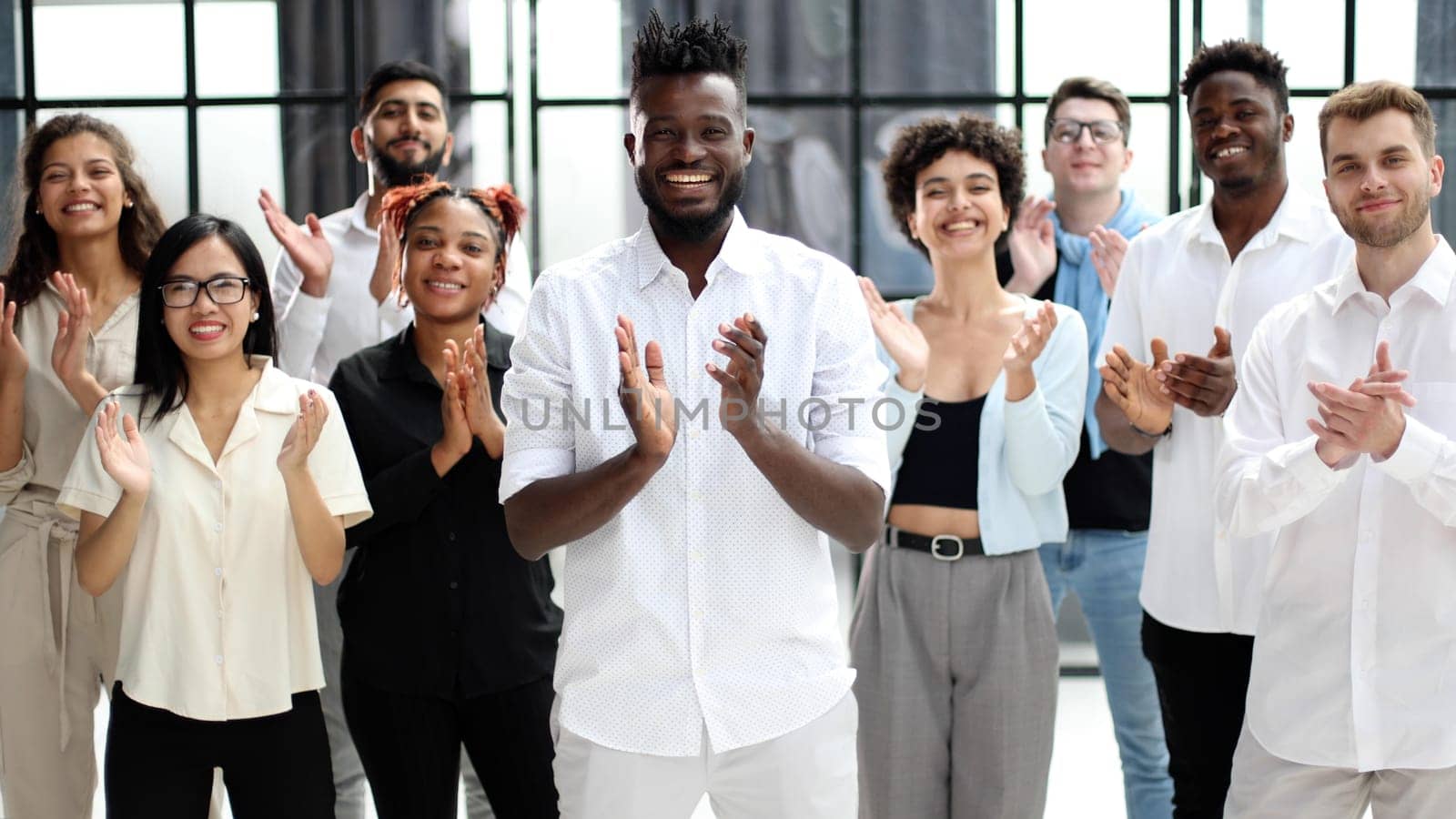 arge international group of happy people applauding together