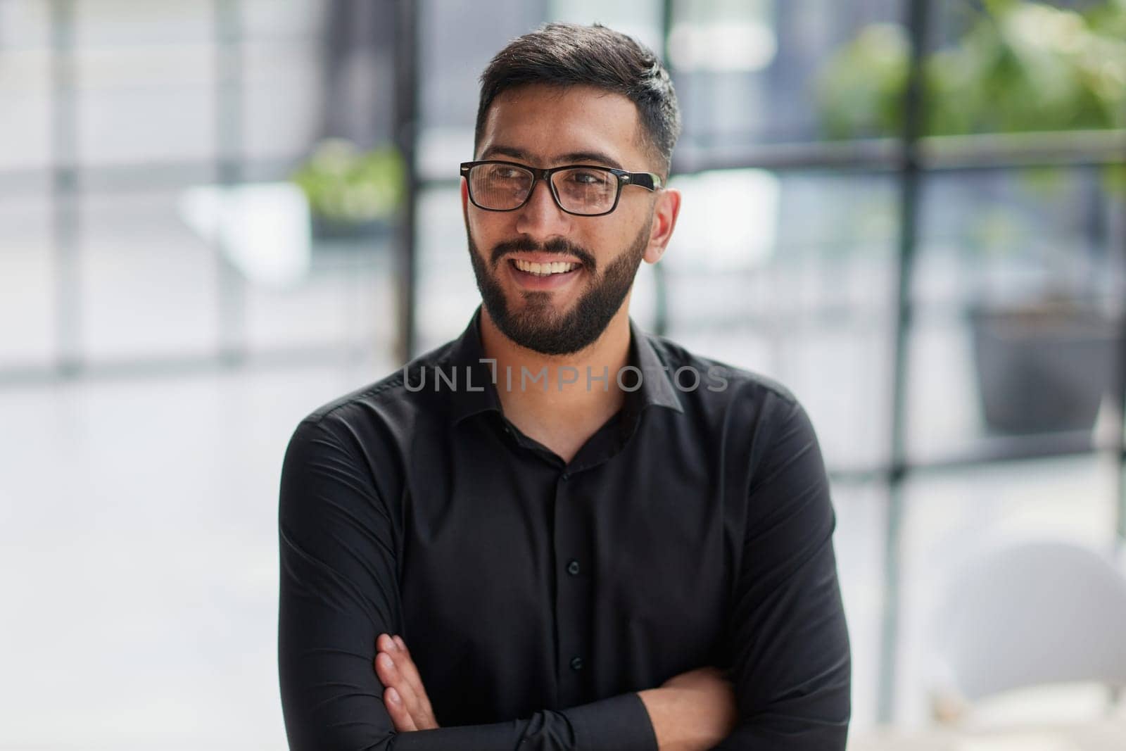 Businessman portrait. Happy confident young businessman standing , smiling, looking at camera.