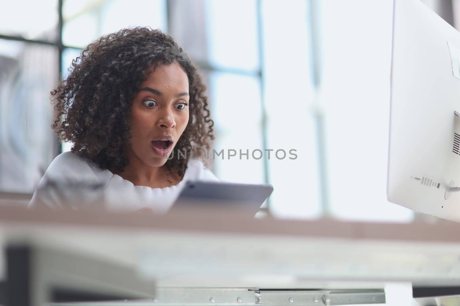 Confident businesswoman with digital tablet in office