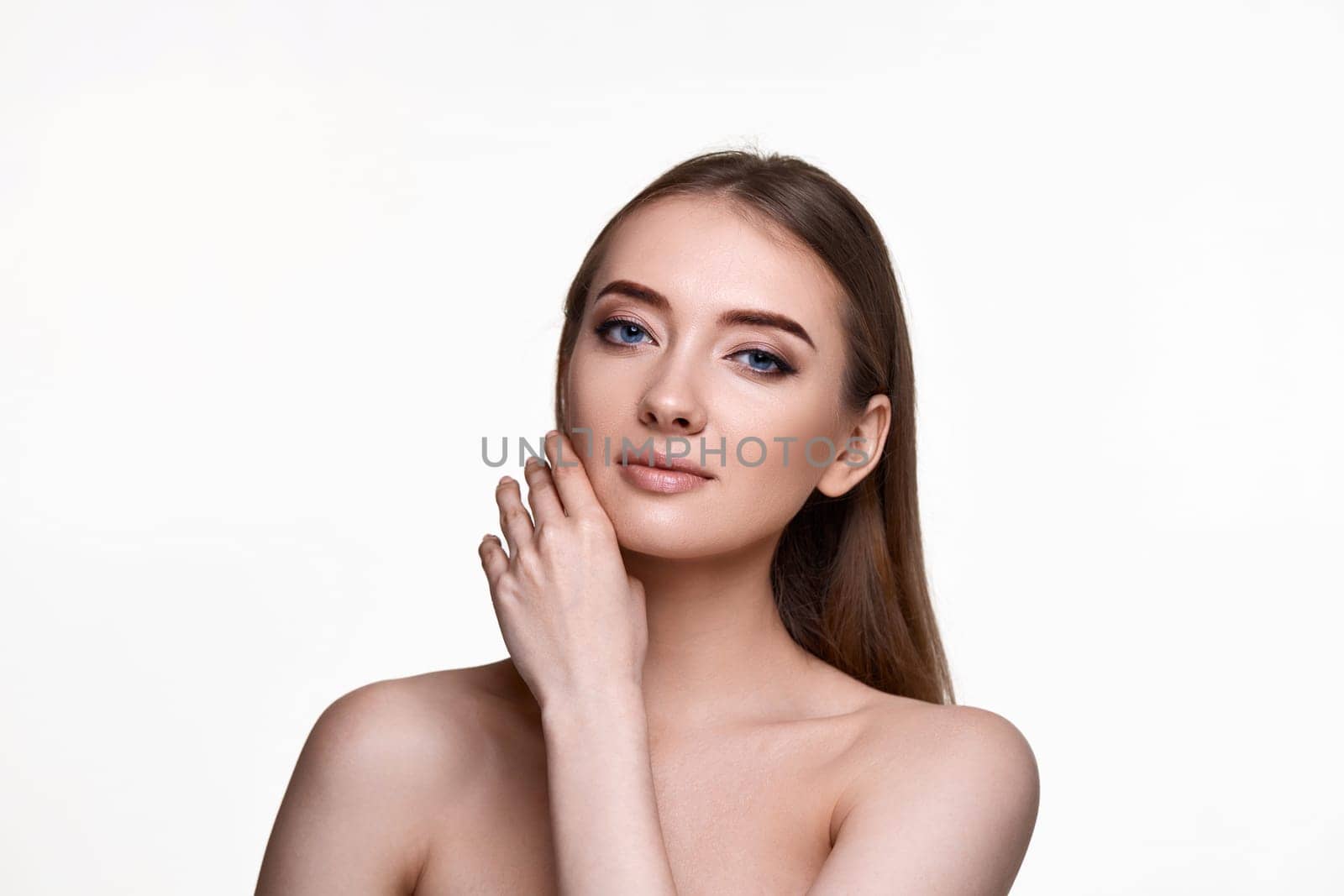 Beautiful young woman touching cheeks and enjoy perfect skin on white background