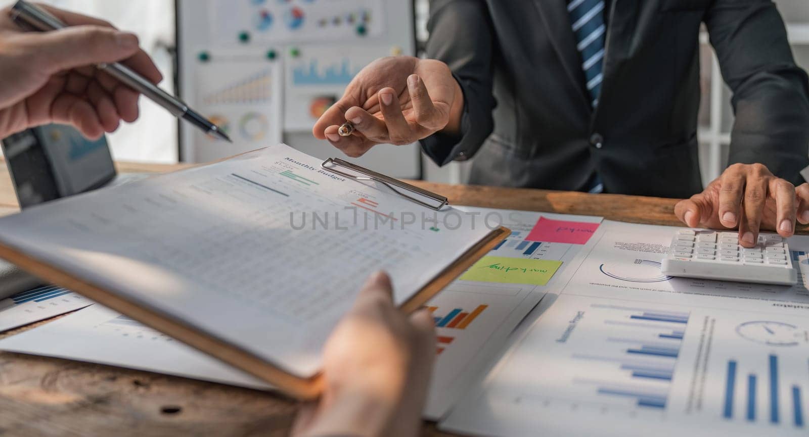 Business team working at office with documents on his desk, doing planning analyzing the financial report, business plan investment, finance analysis concept.