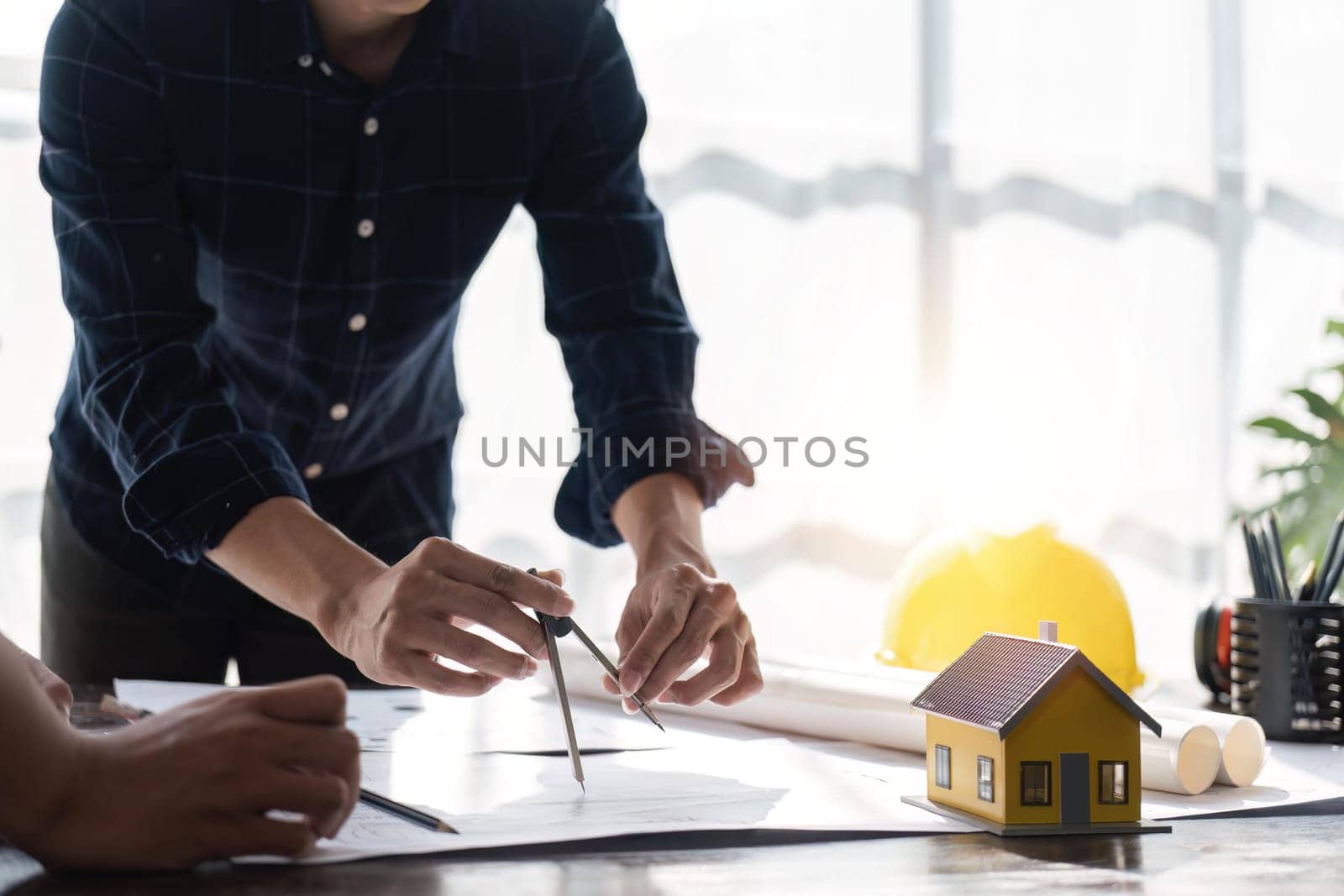 engineer team planning design house, modifying plan, creating construction project and addition according to customer requirement.