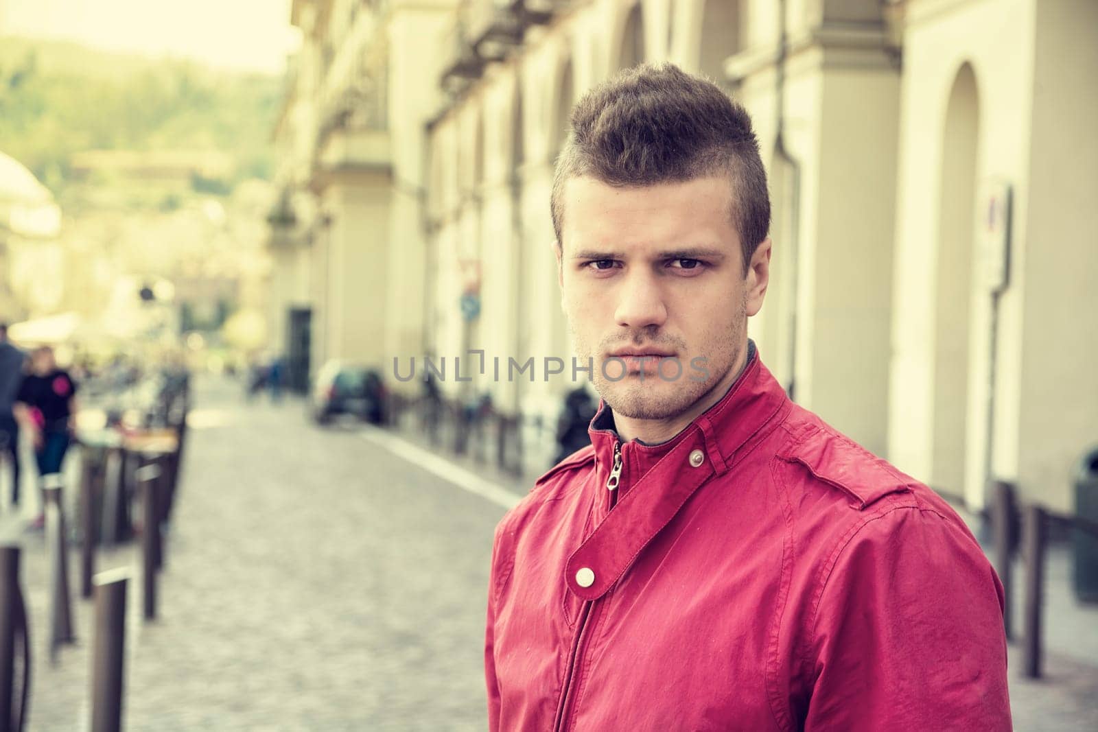 One handsome young man in urban setting in European city