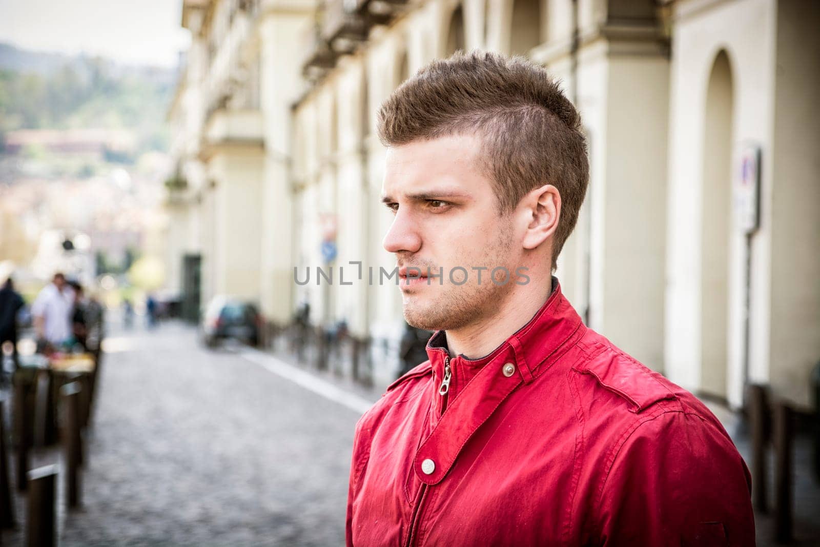 One handsome young man in urban setting in European city