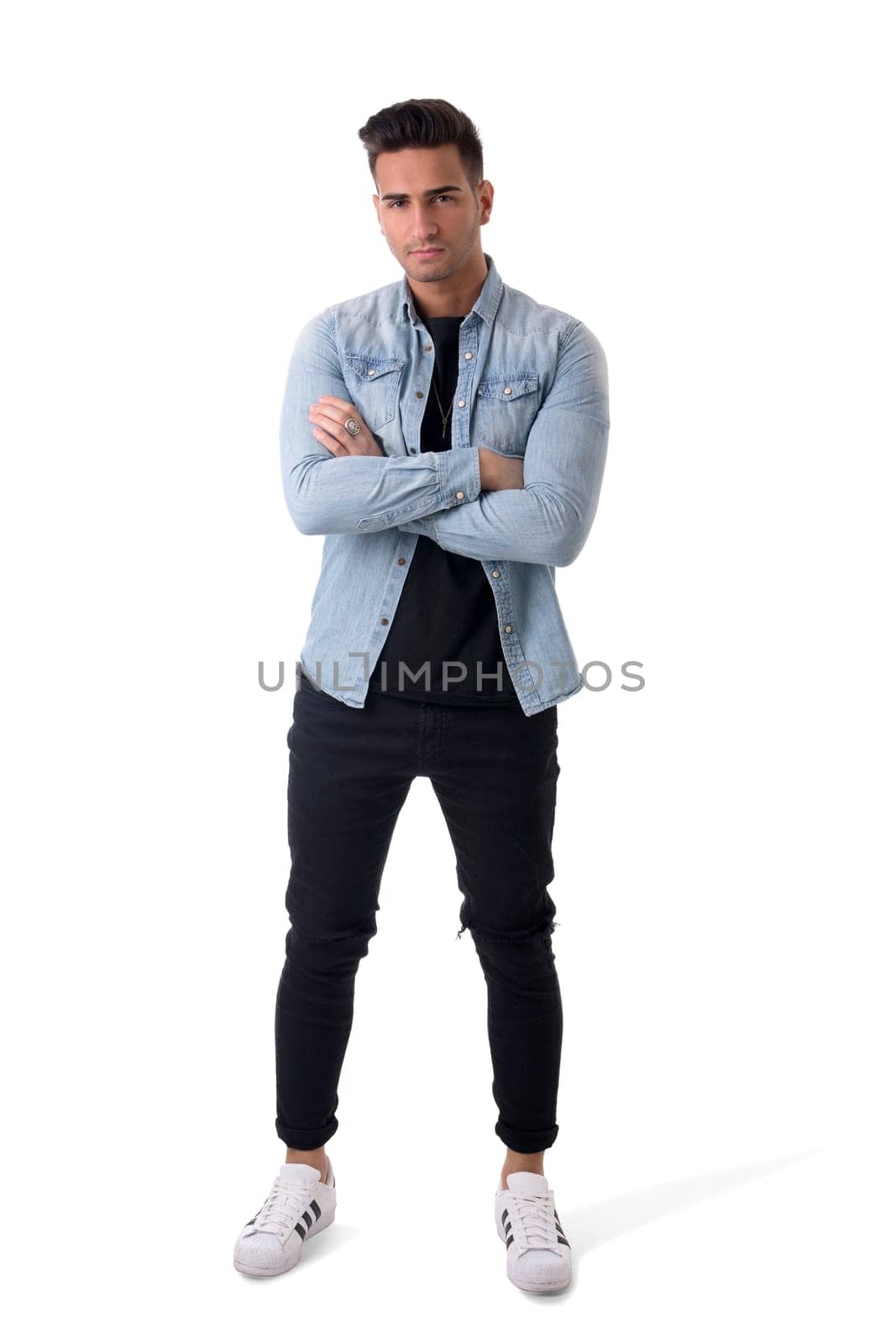 Handsome young man standing with denim shirt and scarf, full length body shot, isolated