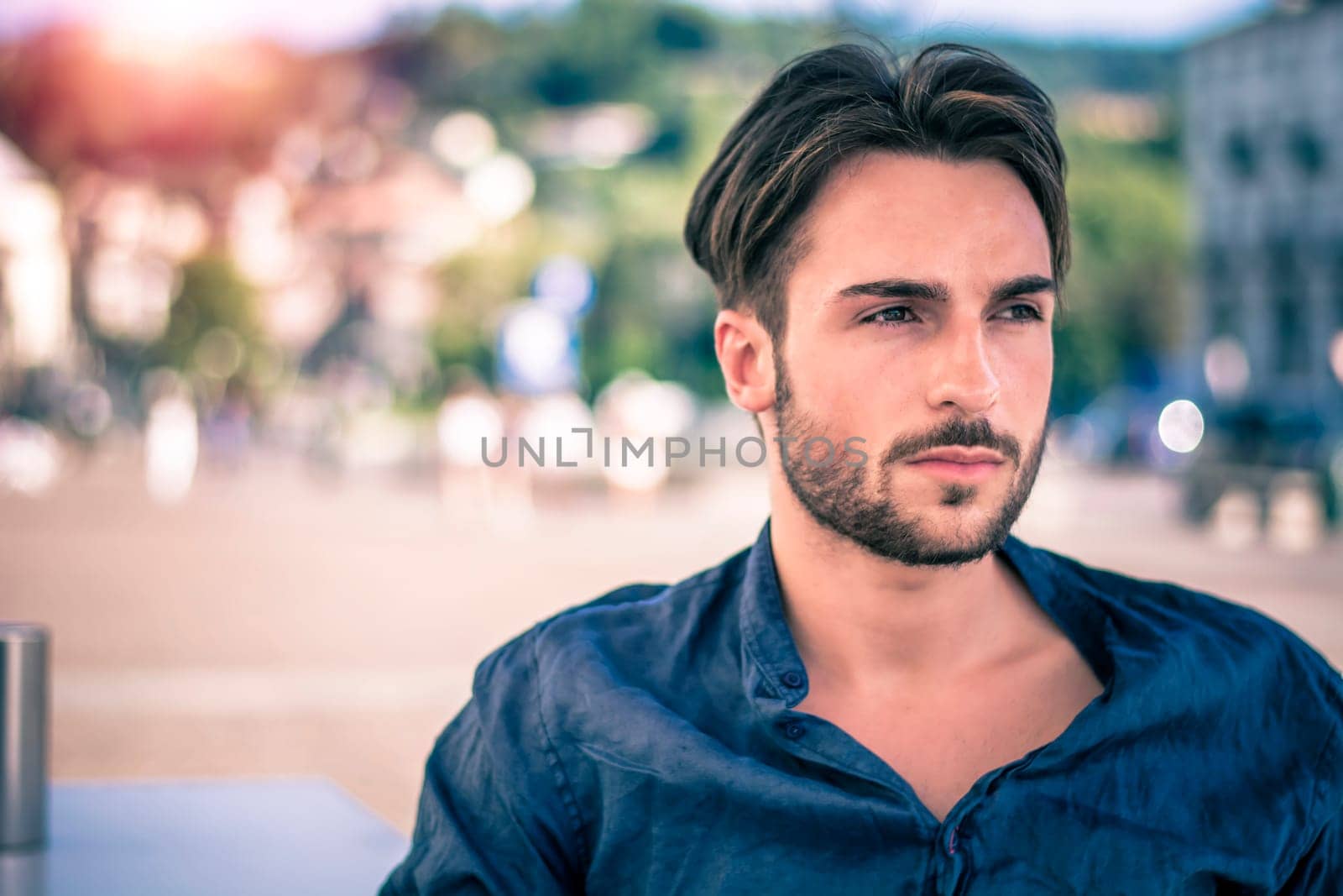 One handsome young man in urban setting in European city, Turin in Italy by the river Po