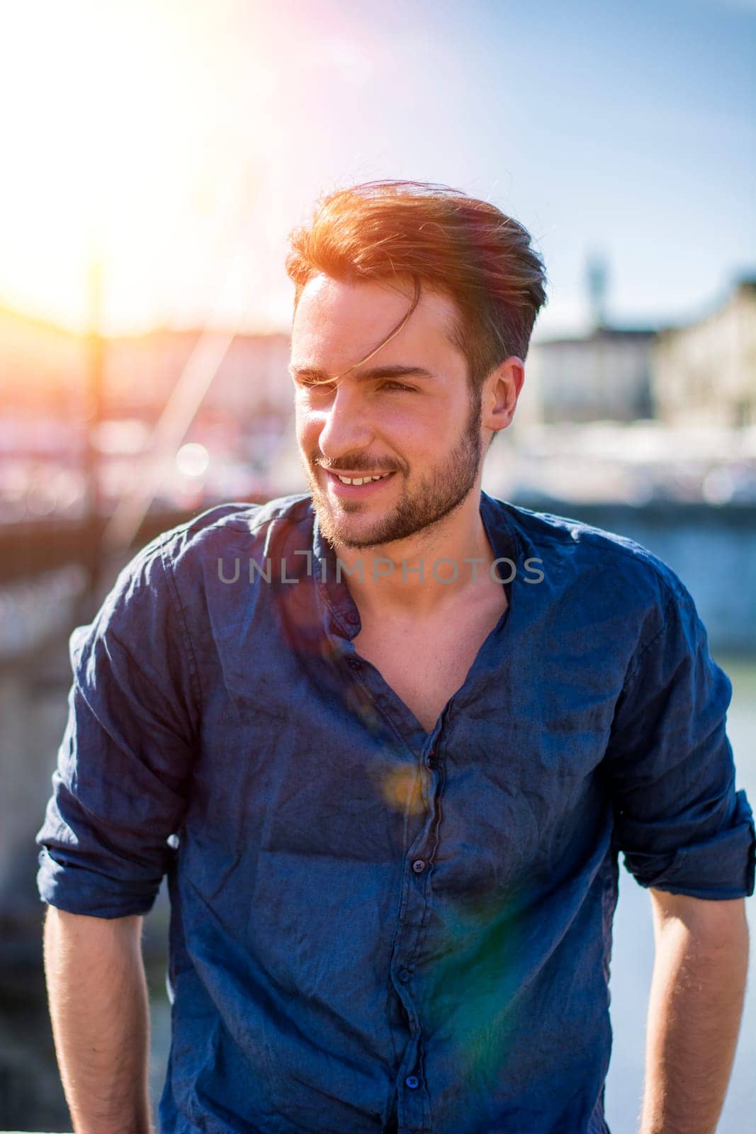 One handsome young man in urban setting in European city, Turin in Italy by the river Po