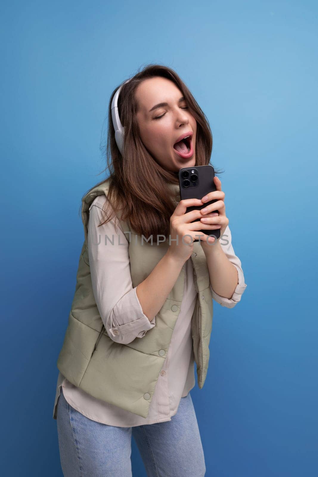 portrait of pretty young brunette woman enjoying music in headphones.