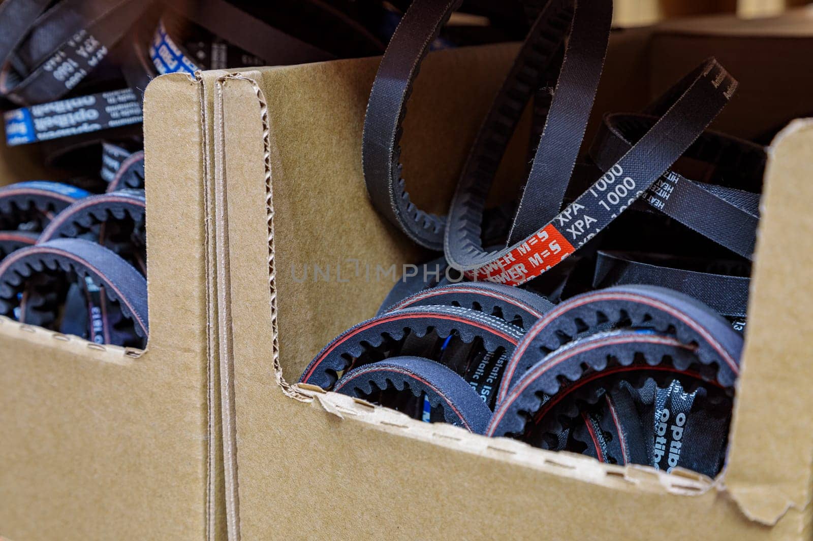 Toothed drive belt for a compressor in a box in stock. Close-up. High quality photo