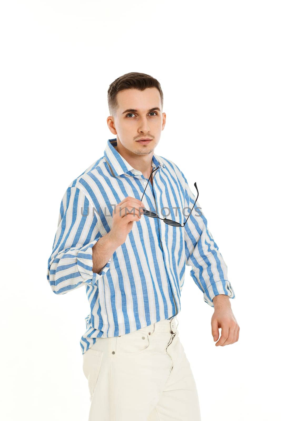 handsome young man in sunglasses and blue striped shirt isolated on white background. Summer fashion