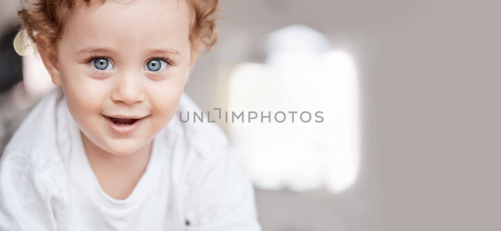 Family, portrait and face of baby boy learning to crawl on living room floor with cute, adorable and sweet smile. Love, relax and young kid smiling in family home for child care, wellness and health by YuriArcurs