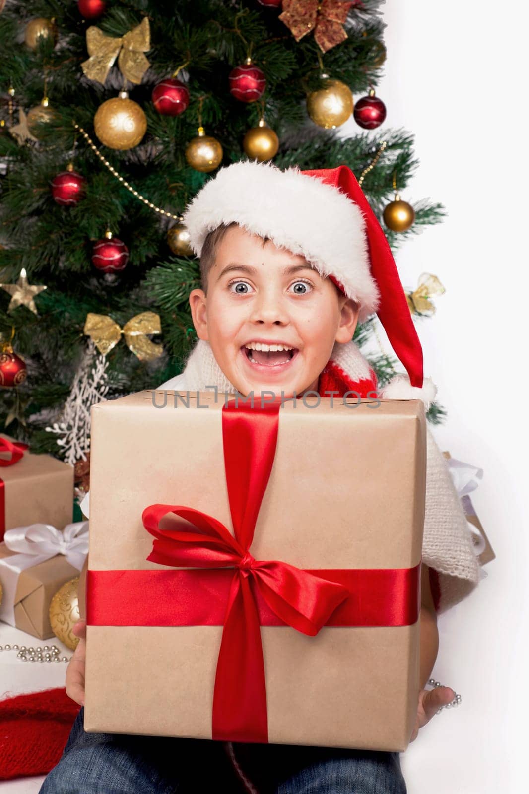 Baby next to the Christmas tree. Christmas Kids. Happy Children Opening Gifts. new year. Boy receiving Christmas gifts by aprilphoto